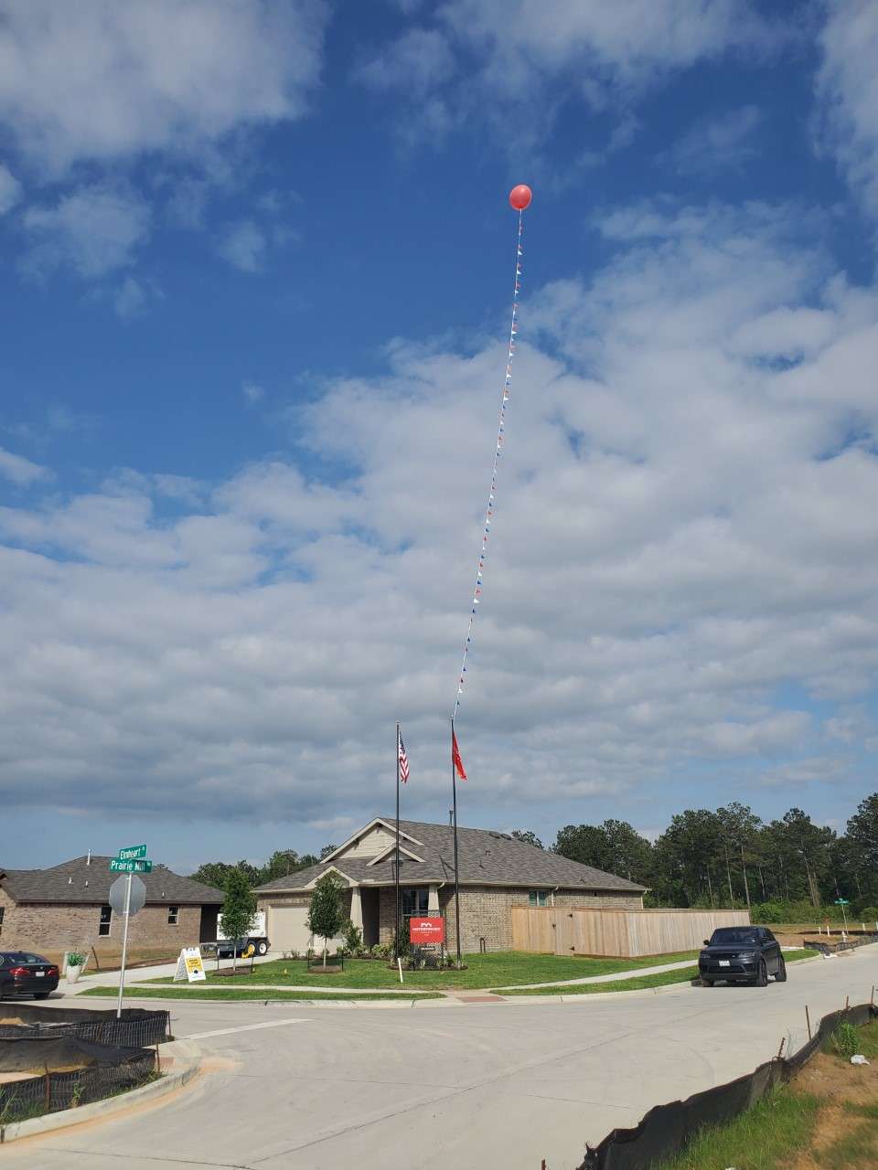 House with balloon and flags